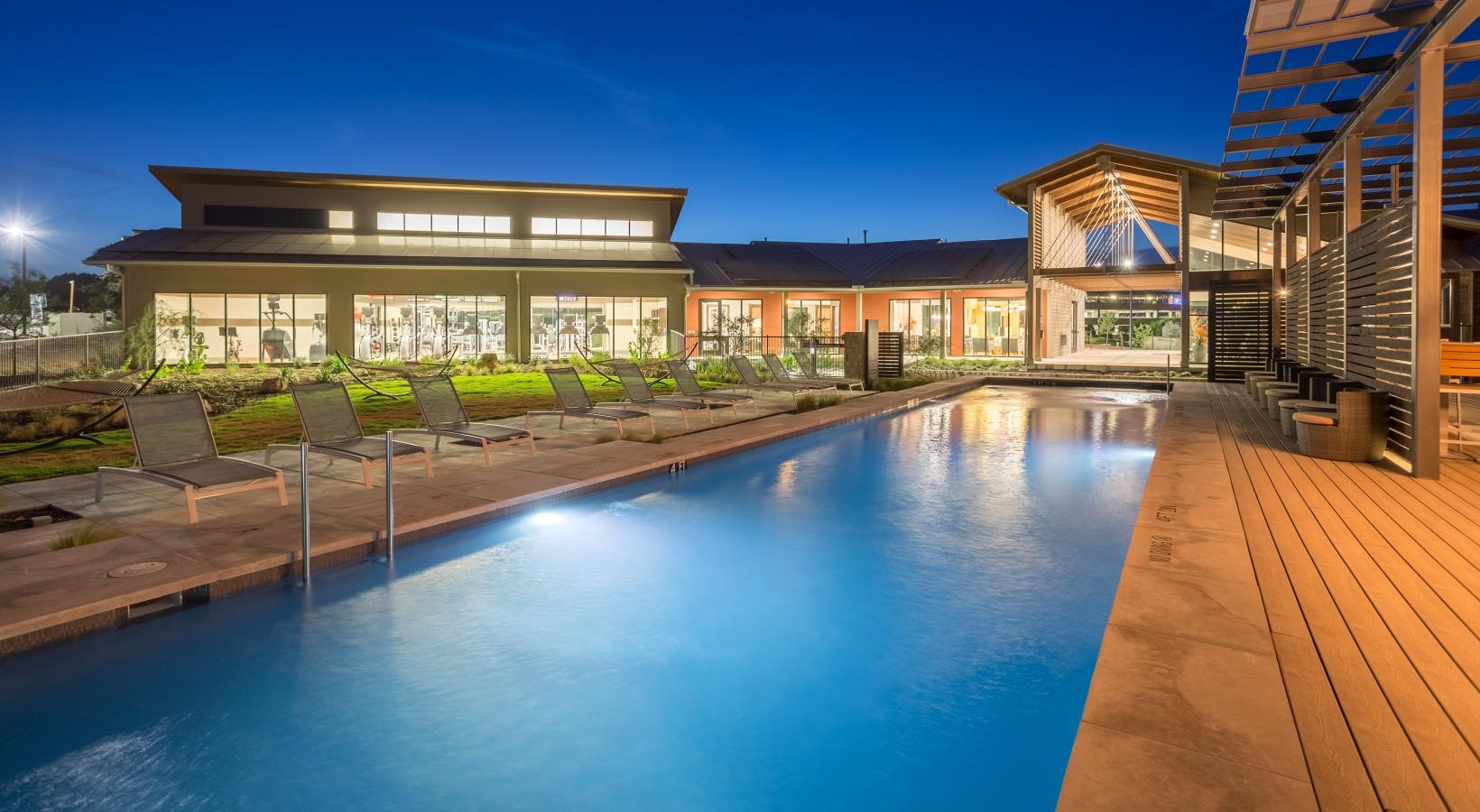 Sparkling swimming pool outdoor pool lit at night