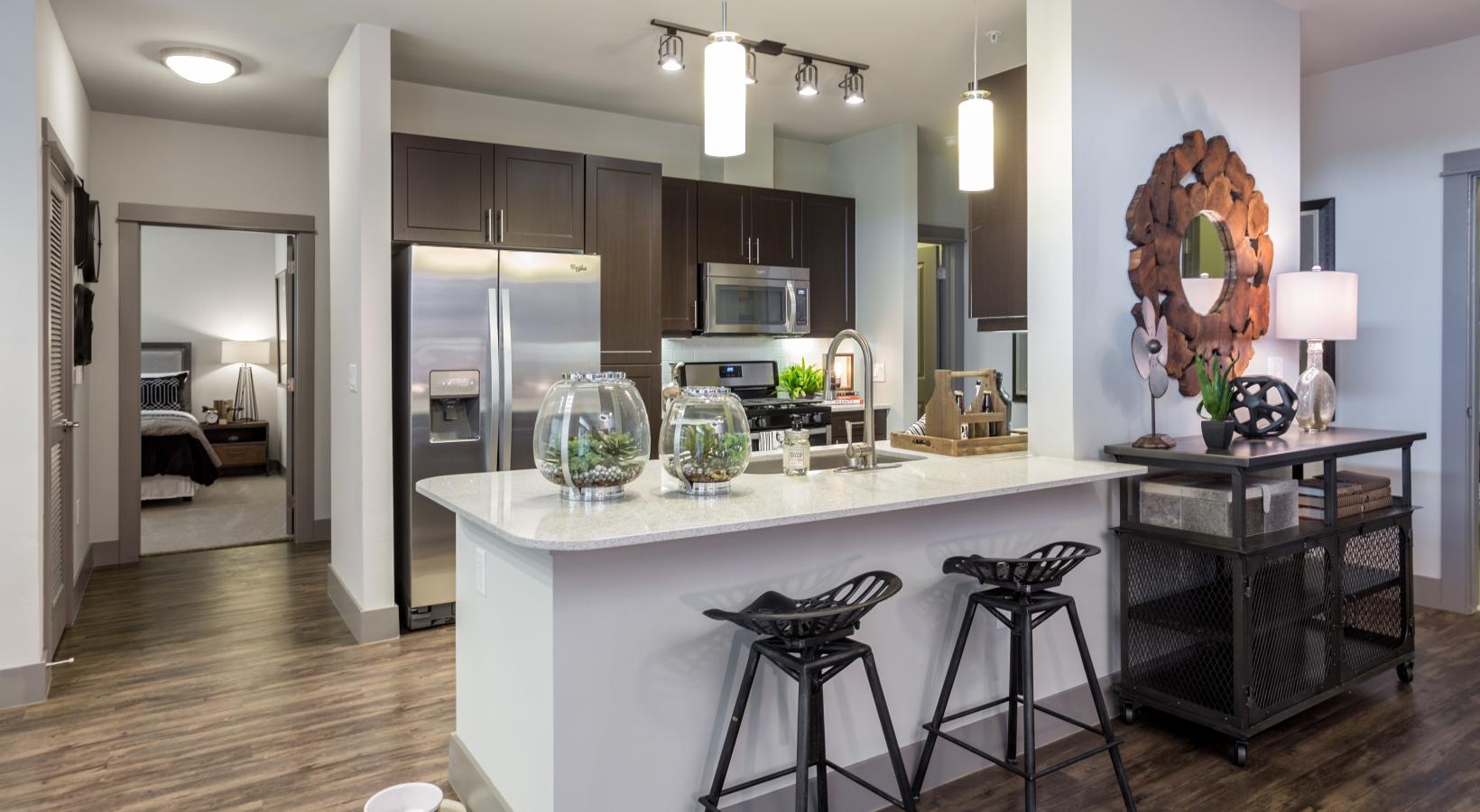 Beautiful kitchens with designer finishes a kitchen with bar stools at open countertop