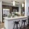 a kitchen with bar stools at open countertop