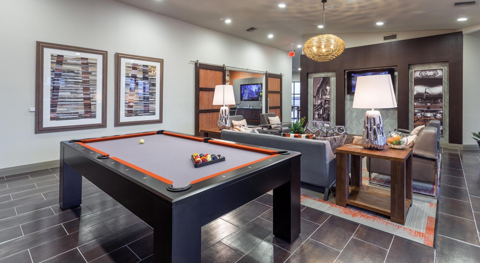 Settle into comfort at Pearl Lantana clubroom with billiards table