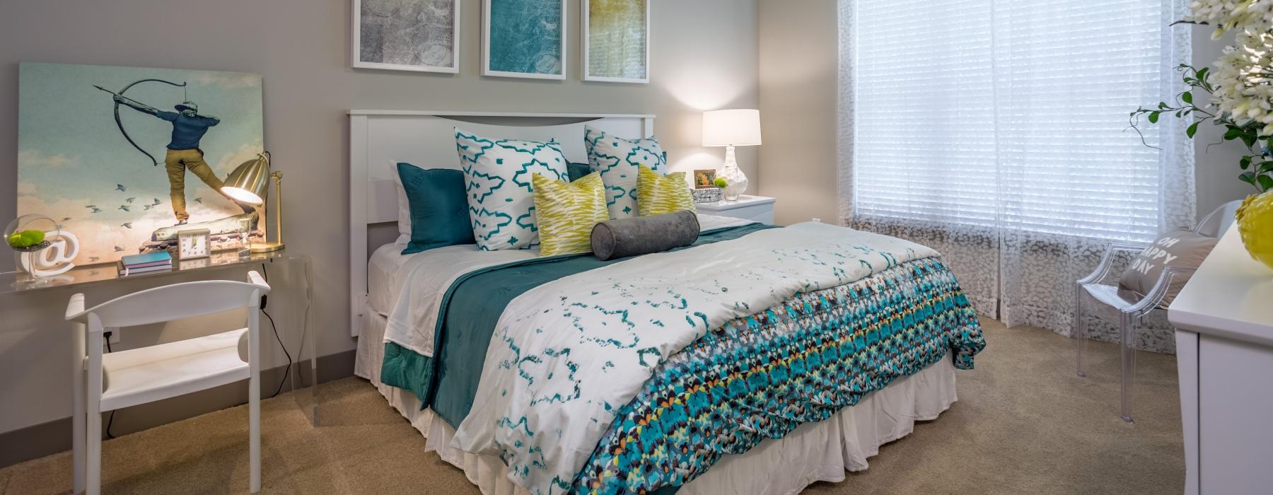 a bedroom with a bed and a chair