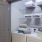 side-by-side washer/dryer units in large laundry closet with light