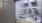 side-by-side washer/dryer units in large laundry closet with light