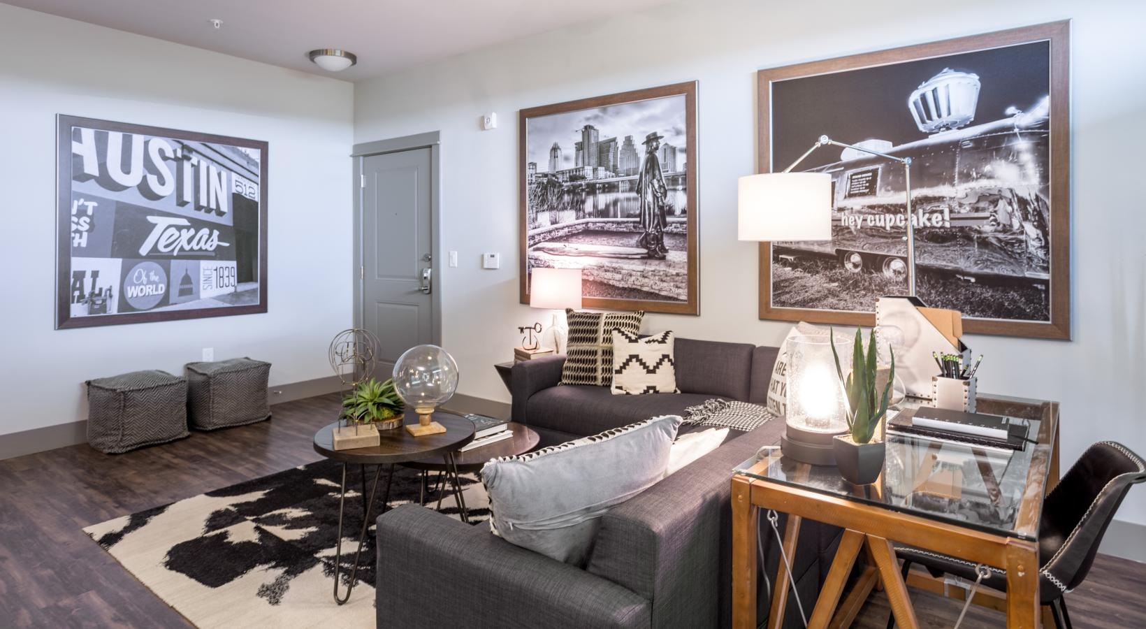 Spacious living areas to recline and recharge a living room with a ceiling fan and art on the wall