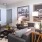 a living room with a ceiling fan and art on the wall