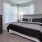 large, carpeted bedroom with windows